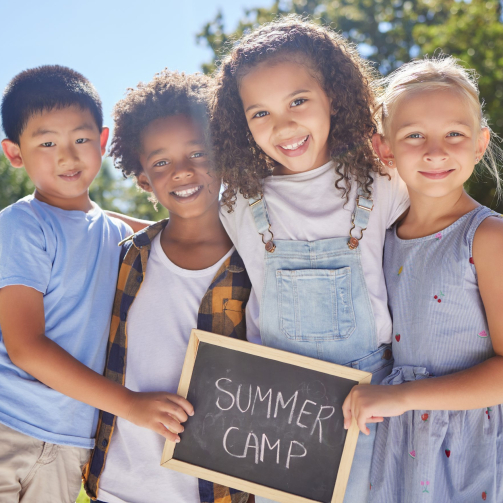 shot-of-a-group-of-friends-holding-a-sign-in-a-out-2023-11-27-04-57-30-utc-scaled
