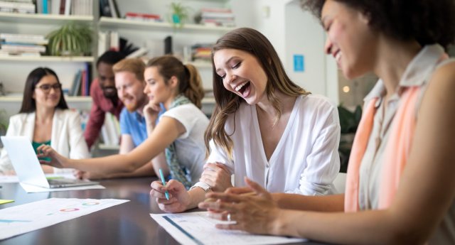 International students laughing in class, enjoying their English communication course at a top language center in Malaysia