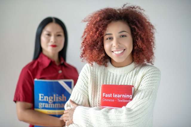 A group of adult learners engaged in an enjoyable IELTS preparation class within an intensive English language cours