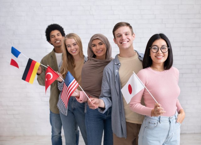 Happy international students gathered together, smiling and sharing their excitement in a lively atmosphere