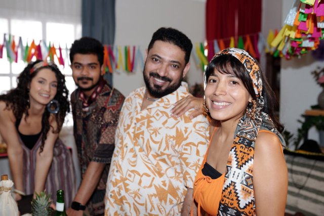 International students laughing and studying English together in a modern Malaysian language centre.