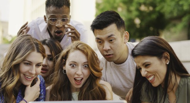 Students from different countries sharing ideas in English during a classroom discussion