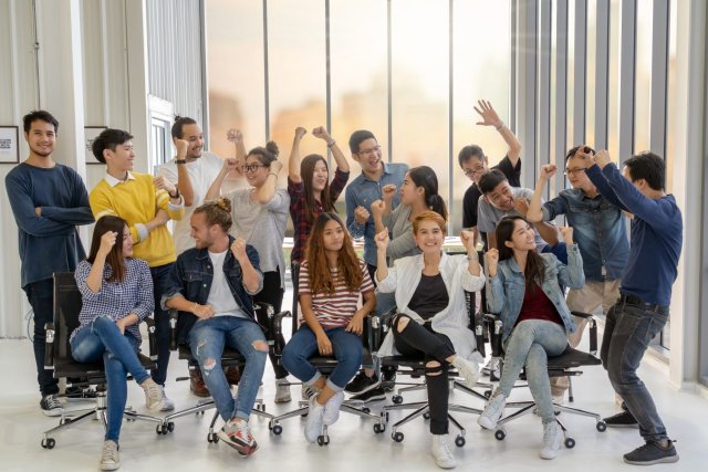 International students joyfully engaged in an English class, sharing smiles and excitement while studying together