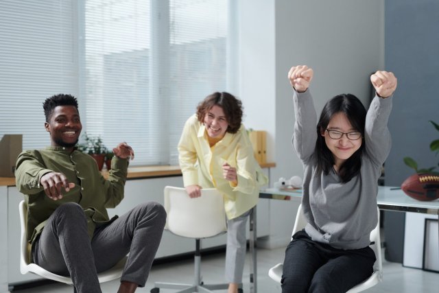 Group of international students laughing and collaboratingduring an interactive classroom activity