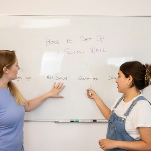 Students practicing English speaking skills in a classroom at VI Academy
